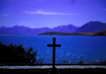 Lake Tekapo seen through the altar window of the Church of the Good Shepard in New Zealandの写真素材