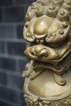 Bronze coloured Oriental sculpture of a lion