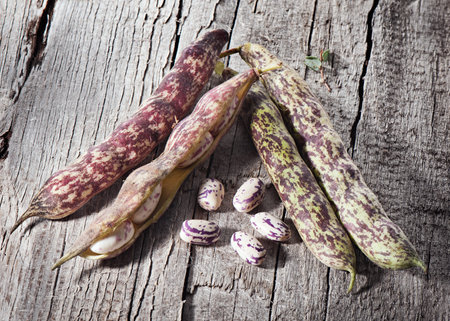 Beans on old wooden board.