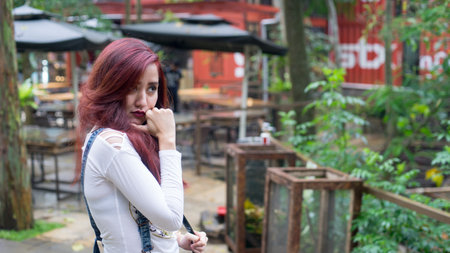 Beautiful asian girl posing in cafe, drinking, walking around and enjoy the environment of the cafeの写真素材