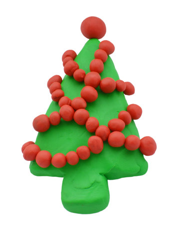Clay Christmas spruce or pine isolated on white background. Icon of hand made plasticine treeの写真素材