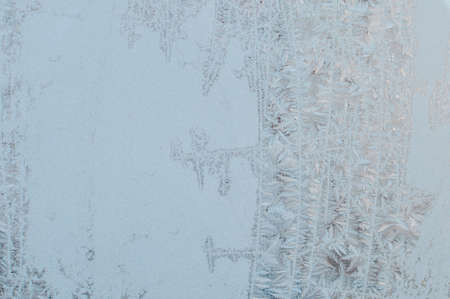 Bright blue frost pattern on a window glassの写真素材