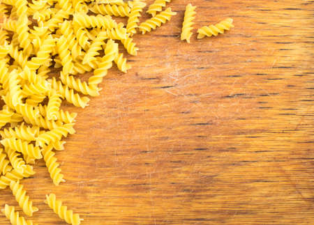 Old Wooden Cutting Board and Dry Pasta. Gastronomy Backgroundの写真素材