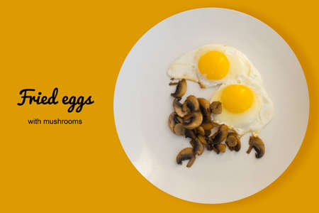 Fried Organic Eggs with Mushrooms on a White Plate Top Viewの写真素材