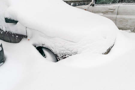 Car Covered With Snow After a Winter Blizzardの写真素材
