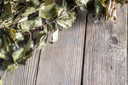 Dark Old Wood Texture with Birch Sauna Broom. Closeup Photo of Timber Background Top Viewの写真素材