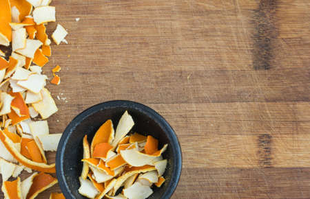 Dry Orange Peel on Wooden Background with Space for Text. Zest Photographed with Natural Light Top Viewの写真素材