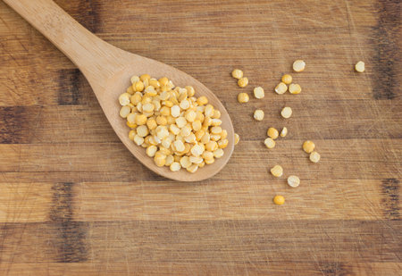 Dry Split Yellow Peas in Wooden Spoon. Healthy Vegetarian or Vegan Food