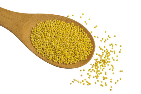 Wooden Spoon with Dry Millet Top View. Vegetarian Food Isolated