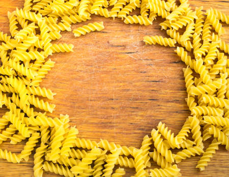 Old Wooden Cutting Board and Dry Pasta. Gastronomy Backgroundの写真素材