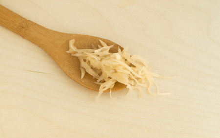Homemade Sauerkraut and Carrots on Wood Background Photographed with Natural Light