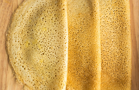 Thin Pancakes on a Wooden Background Top View. Fresh Homemade Crepes Flat Lay