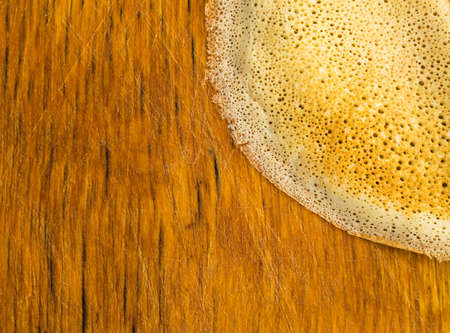 Thin Pancakes on a Wooden Background Top View. Fresh Homemade Porous Crepes Flat Layの写真素材