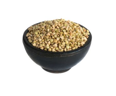 Dry Green Buckwheat Grain in Round Black Bowls Isolated on a White Backgroundの写真素材