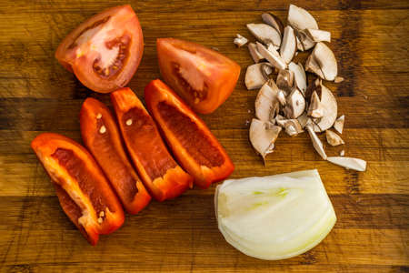 Chopped Vegetables on Cutting Board. Sliced Tomato, Bell Pepper, Onion, Mushroomの写真素材