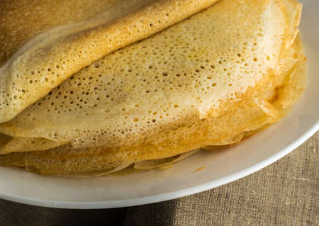 Stack of Thin Pancakes on a White Plate. Fresh Homemade Crepesの写真素材