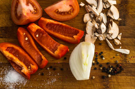 Chopped Vegetables on Cutting Board. Sliced Tomato, Bell Pepper, Onion, Mushroomの写真素材