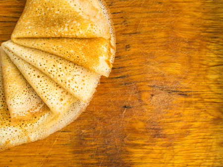 Thin Pancakes on a Wooden Background Top View. Fresh Homemade Crepes Flat Layの写真素材