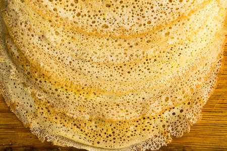 Thin Pancakes on a Wooden Background Top View. Fresh Homemade Crepes Flat Layの写真素材