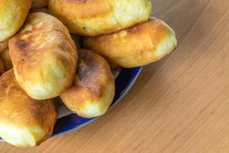 Traditional Homemade Baked Patties or Pies with Jam On Wooden Board. Fried Russian Pirozhki made from Yeast Dough in Rustic Styleの写真素材