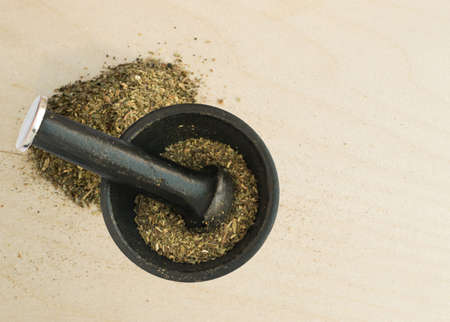 Heap of Dried Basil Flakes Over Rustic Wooden Background with Copy Spaceの写真素材