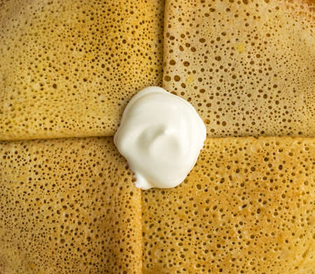Thin Pancakes with Sour Cream Top View. Fresh Homemade Crepesの写真素材
