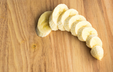 Sliced Banana on a Wooden Background Top Viewの写真素材