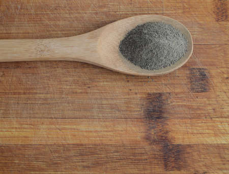 Heap of Ground Black Pepper in Wooden Spoon Top Viewの写真素材