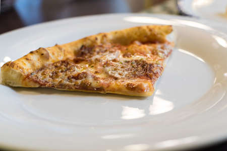 Fresh Hot Pizza with Pepperoni Sausage and Mozzarella Cheese Sprinkled with Herbs. Selective Focusの写真素材