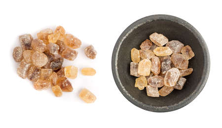 Large Crystals of Natural Unrefined Cane Sugar. Brown Lump Caramelized Saccharose on White Backgroundの写真素材