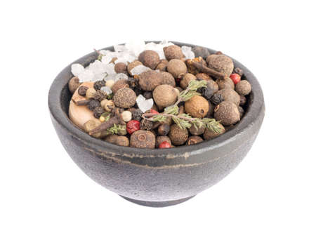 Heap of Dry Spices with Thyme and Black Pepper in Black Bowl on White Backgroundの写真素材