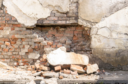 Old Broken Brick Wall with Large Pieces of Plaster. Old Collapsing Building