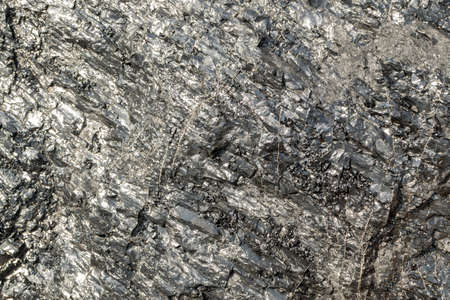 Beautiful Brilliant Piece of Coal that can be used as Stone Background. Natural Black Anthracite Texture with Shining Surfaceの写真素材