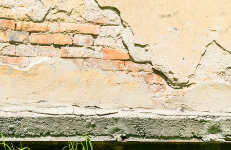 Grunge Background with Dirty Lime Plaster and Dark Cracks. Aged Wall Texture