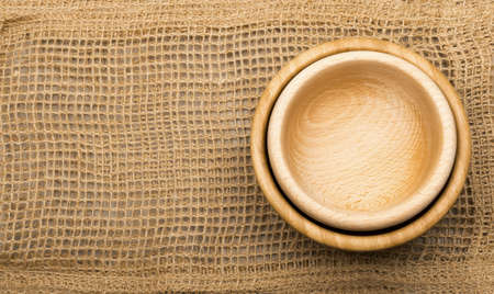 Rustic Burlap Background with Wooden Spoons Top View. Old Linen Canvas with Place for Text or Copyspaceの写真素材