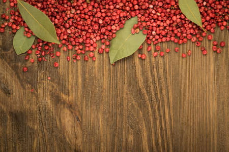 Pink Pepper or Red Pepper Corns on Wooden Background. Schinus Dry Seedsの写真素材