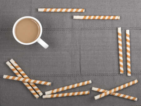 Chocolate Wafer Sticks and Cup of Coffee with Milk on Gray Background Top Viewの写真素材