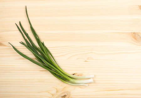 Bunch of Young Green Onion on Wooden Background. Spring Onion Top View and Flat Layの写真素材