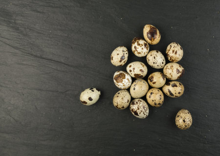 Quail Eggs on Stone Background Closely. Small Whole Eggs Top View with Place for Text