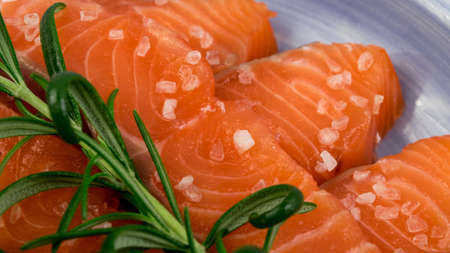 Crepes with Raw Sliced Salmon Fillet. Thick Pieces of Red Trout with Pancakes on Blue Plateの写真素材