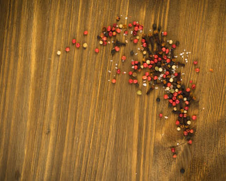Pink Pepper or Red Pepper Corns on Wooden Background. Schinus Dry Seeds on Wood Rustic Tabletopの写真素材
