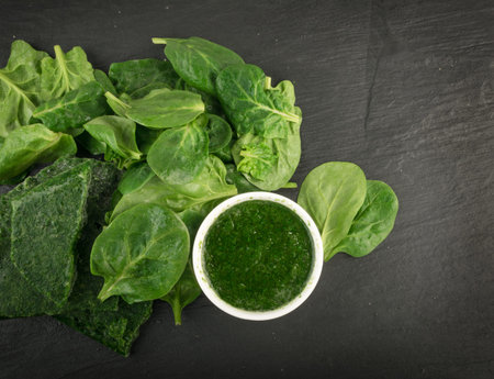 Fresh Baby Spinach Leaves. Unfrozen Spinacia Oleracea in White Bowl. Leafy Green Vegetable Top View