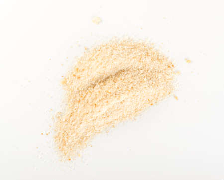Heap of Bread Crumbs on White Paper Top View. Crushed Rusk Bread Crumbs or Panko Isolatedの写真素材