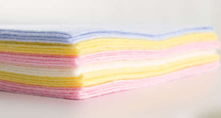 Pastel Color Fabric Background or Texture. Stack of Folded New Soft Color Cloth. Absorbent Microfiber Towels with Place for Textの写真素材