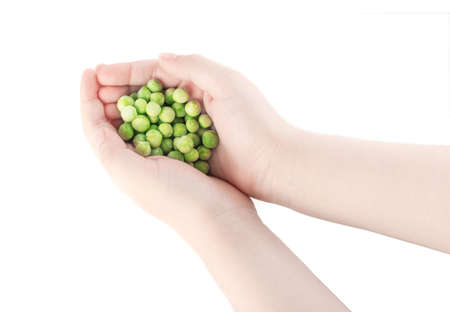 Heap of Frozen Sweet Green Peas in Child Hands Isolated on White Background Top Viewの写真素材