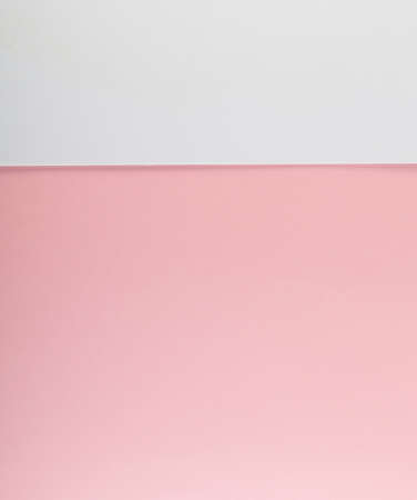 Pastel colored paper card background. Abstract simple white and pink pattern with place for textの写真素材