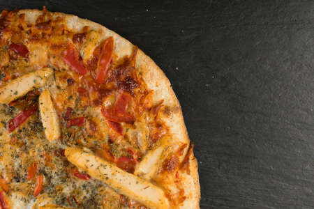 Whole Round Chicken Pizza on Natural Stone Background Top View. Italian Food with Place for Textの写真素材