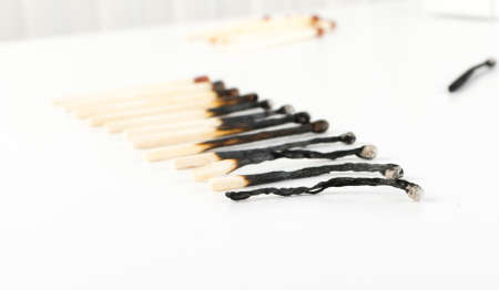 Different Stages of Match Sticks Burning or Safety Matches on White Paper. Macro Photography of Matchsticks Top Viewの写真素材