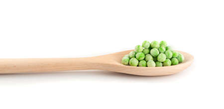 Heap of Frozen Sweet Green Peas in Wooden Spoon Isolated on White Backgroundの写真素材
