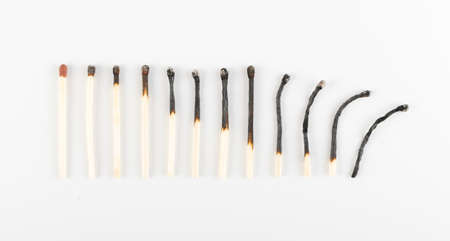 Different Stages of Match Sticks Burning or Safety Matches on White Paper. Macro Photography of Matchsticks Top Viewの写真素材
